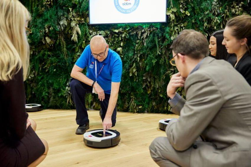 Mitie employee demonstrating how to use a robotic floor cleaner at the Centre and Hygiene Centre of Excellence